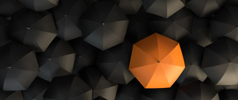 Red umbrella in crowd